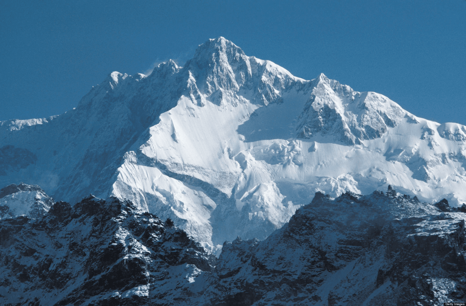 Mount Kangchenjunga snow peak with Buddhist monastery and prayer flags above Sikkim Himalayan valley