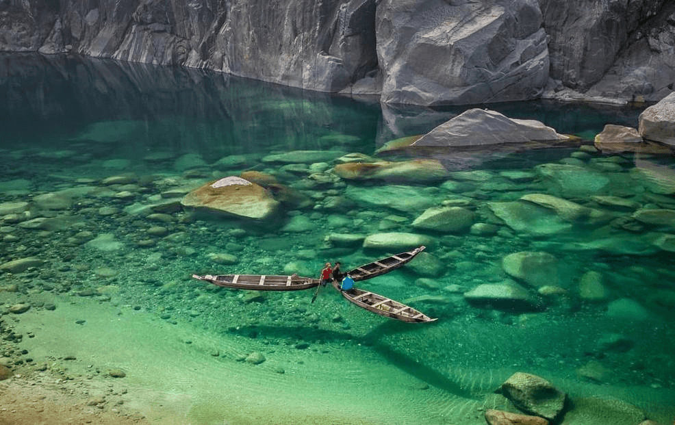 Crystal clear Umngot River at Dawki Meghalaya with boat floating on transparent water near India Bangladesh border
