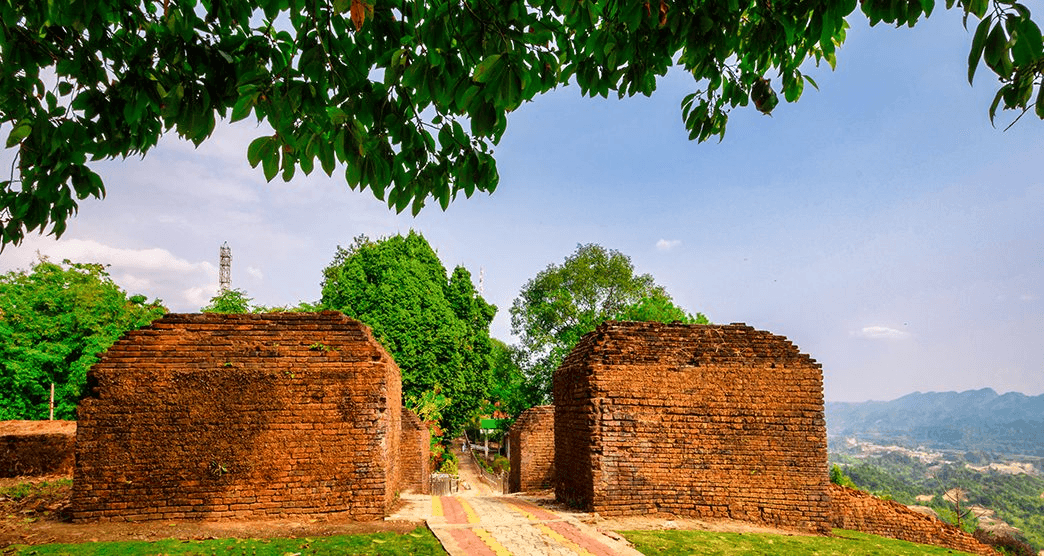 Ita Fort 14th-century brick ruins surrounded by lush green forest in Itanagar, Arunachal Pradesh, with nearby Ganga Lake and tribal culture.